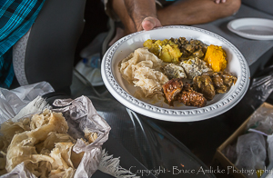 Taste of Trini Dish - Potato and Chana Curry, Curry Pumpkin, Chicken Curry Gizzard, Fried Shark, Stewed Chicken, Roti Bread, Dahl Puri, and Curry Mango